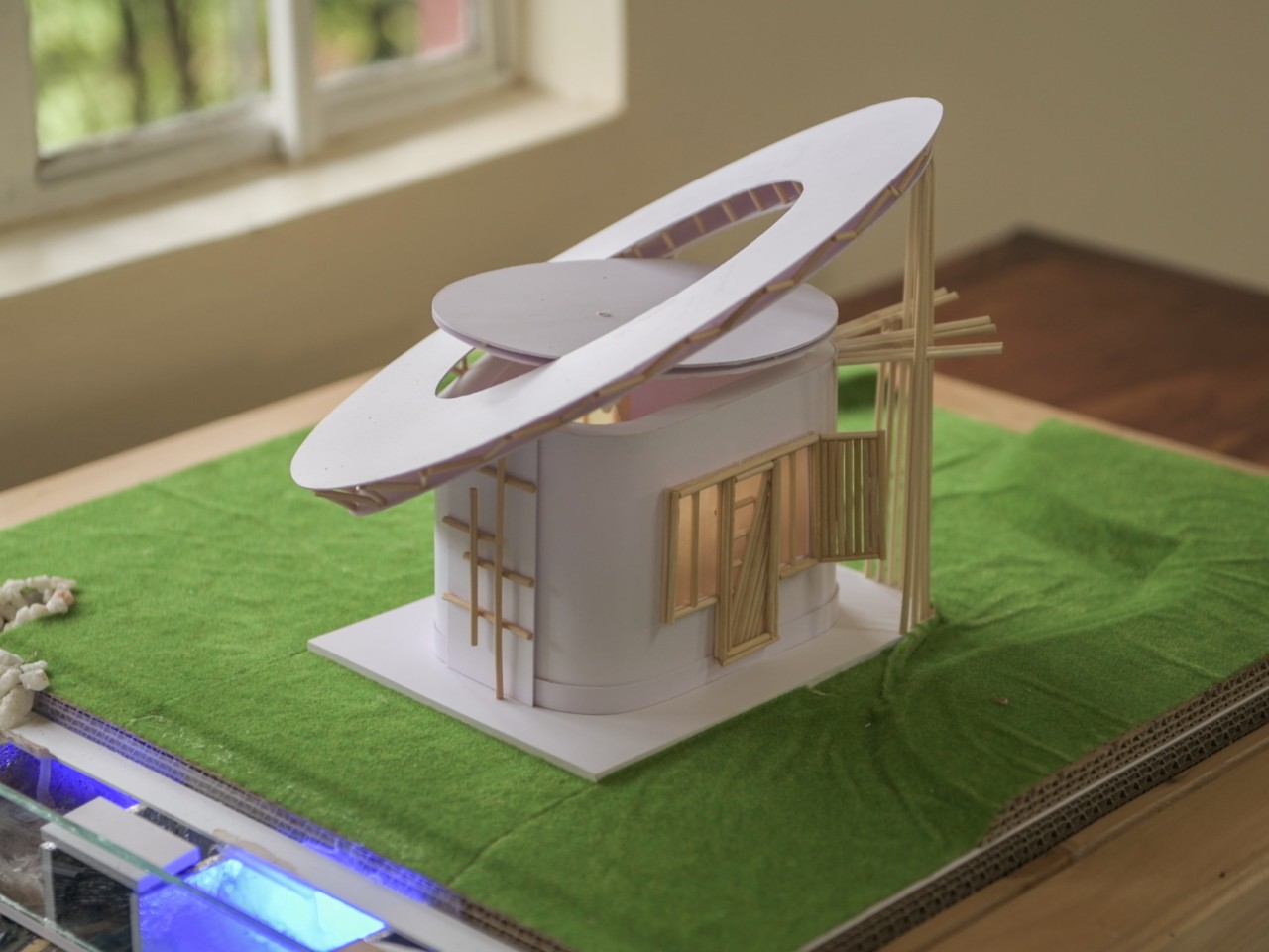 Model of small building with a slanted circular roof