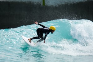 a boy surfs at an inland surfing park