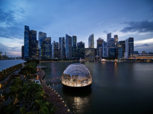 A floating apple store dome in front of the singapore skyline