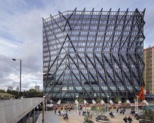 Exterior of the Brunel Building, a glass skyscraper covered in steel exoskeleton