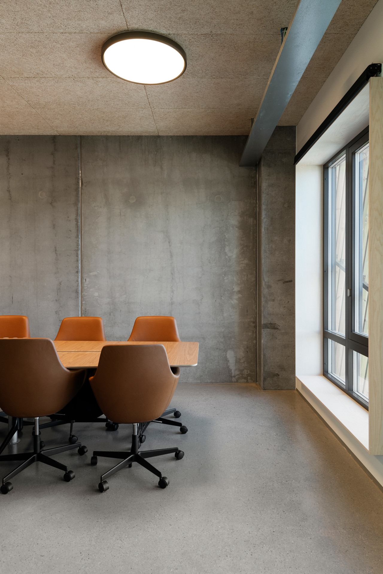A stark powerhouse meeting room with concrete floor