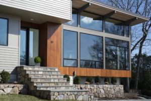 A hilltop home fronted with wood from the Acorn Deck House Company
