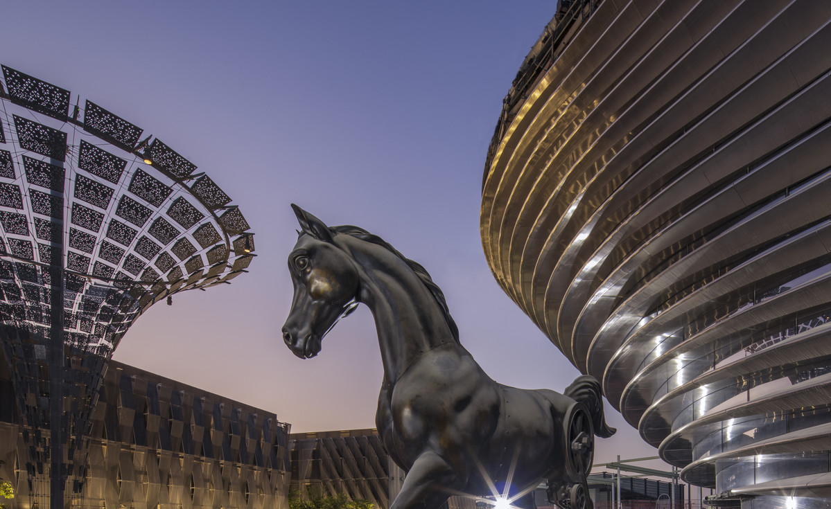a horse statue surrounded by futuristic buildings