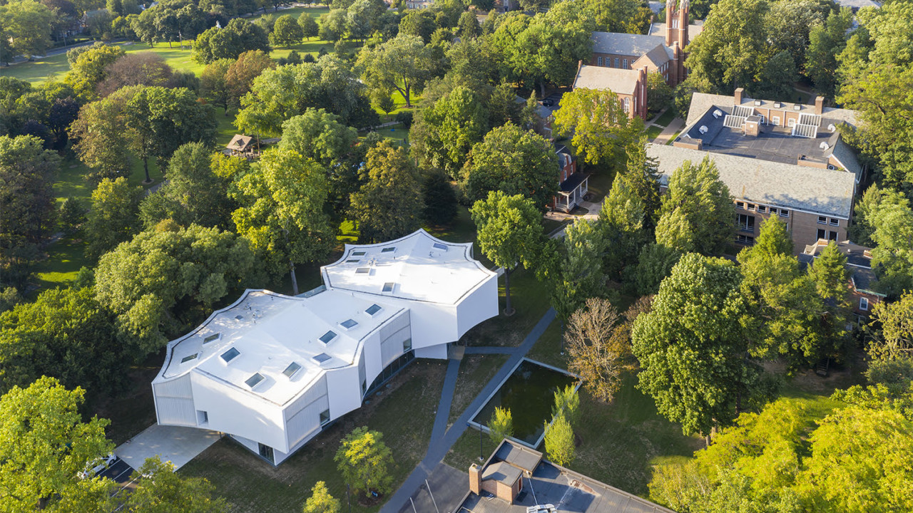 Aerial photo of a white arts center among the trees