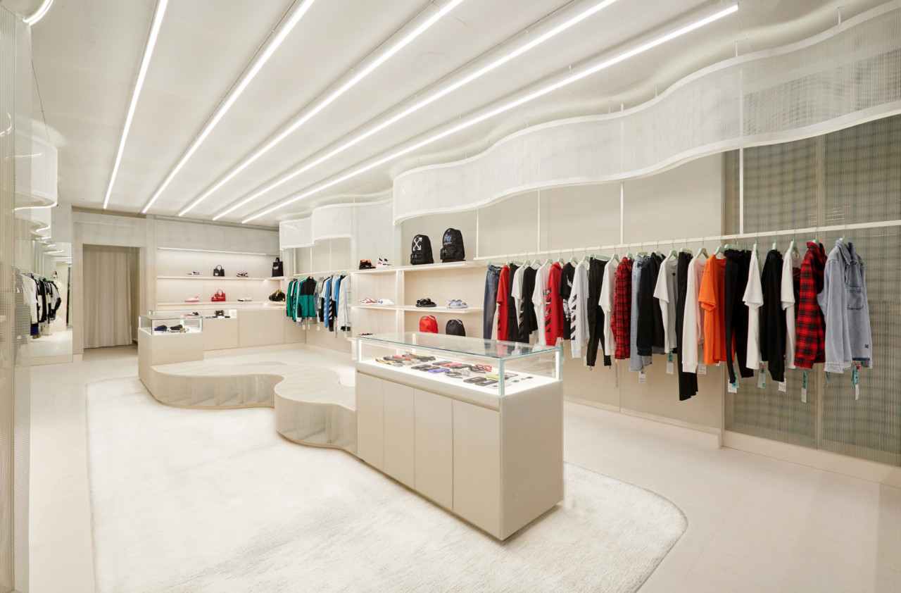 Interior of a james wines designed white retail store with curving shelves