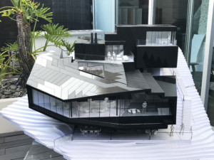 Model of a black ski lodge with rivers of windows