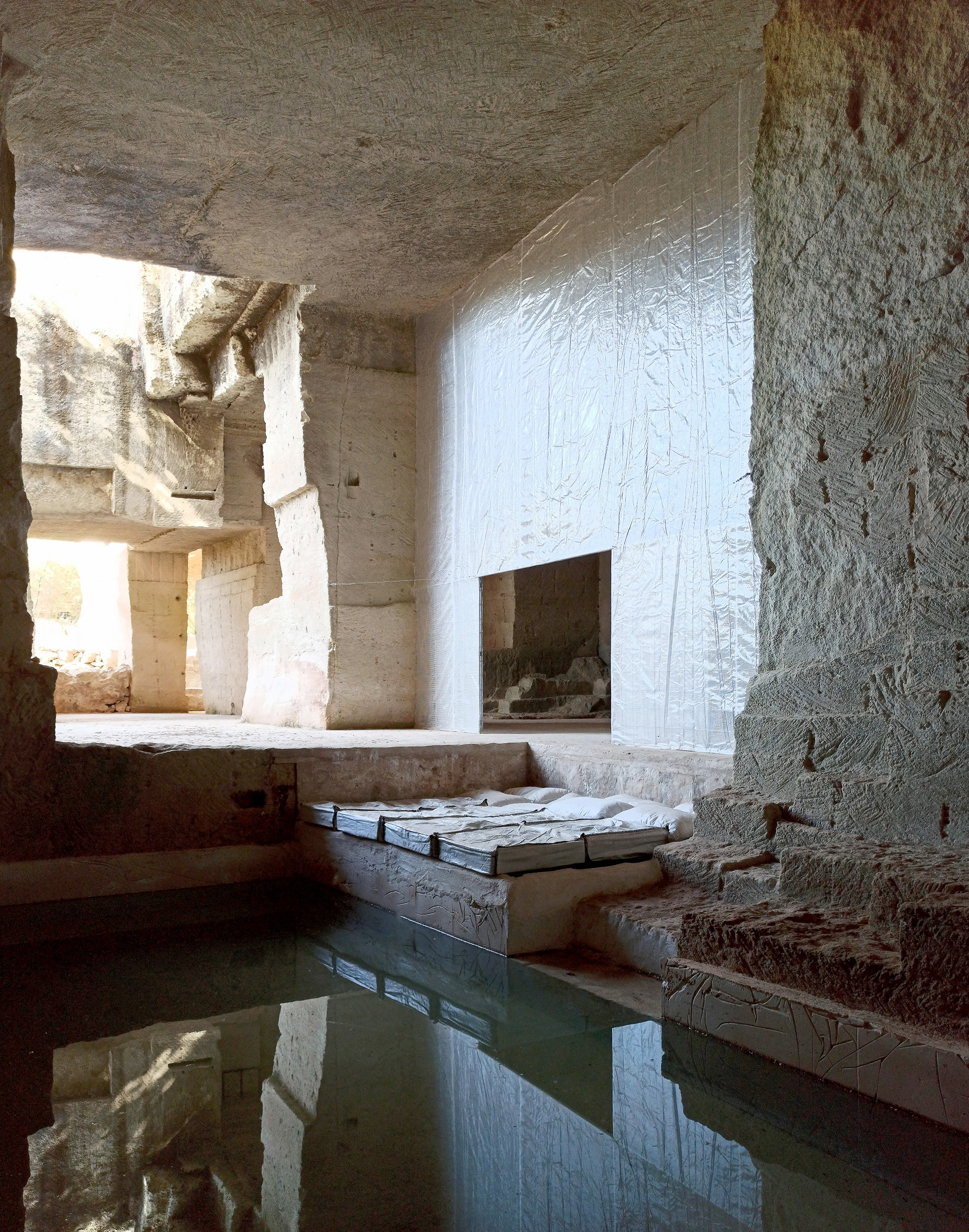 The pool inside of a limestone house