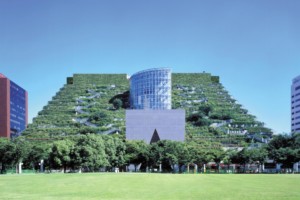 a building covered with trees with glass building in the center