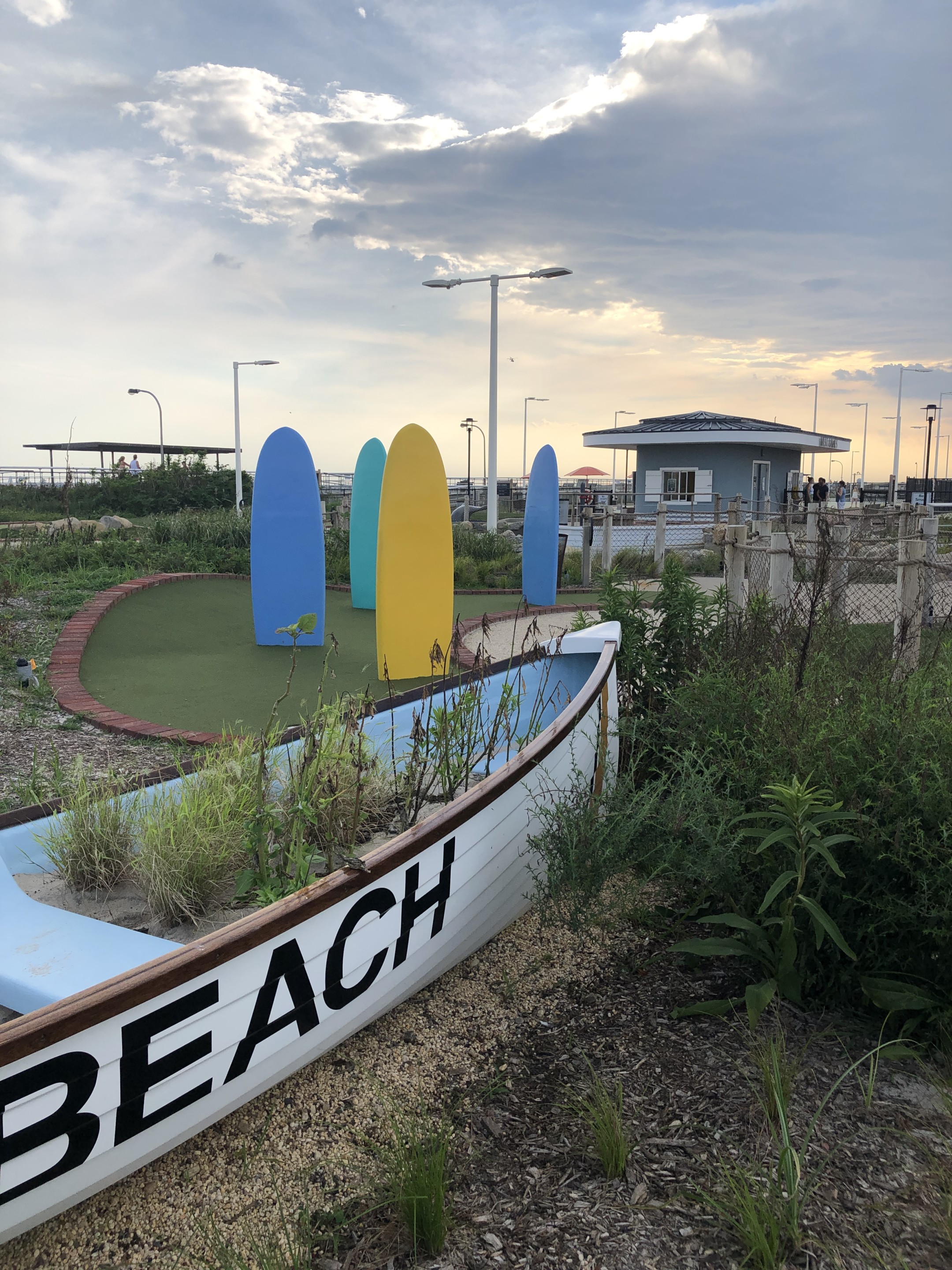Yellow and blue boards sticking out of mini-golf dunes