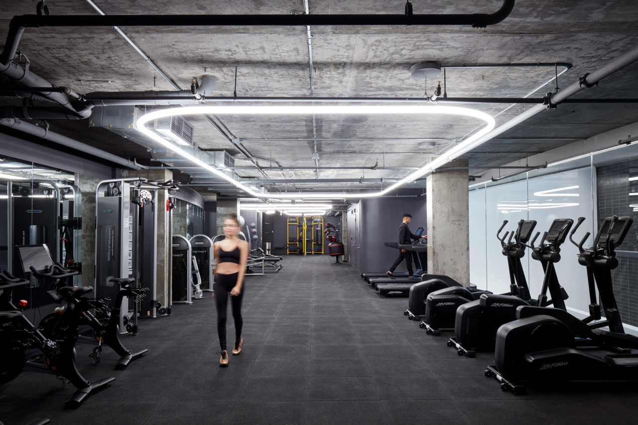 A gym with raw concrete ceiling