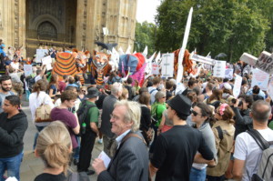 Protestors gathered at a climate march in london waving signs