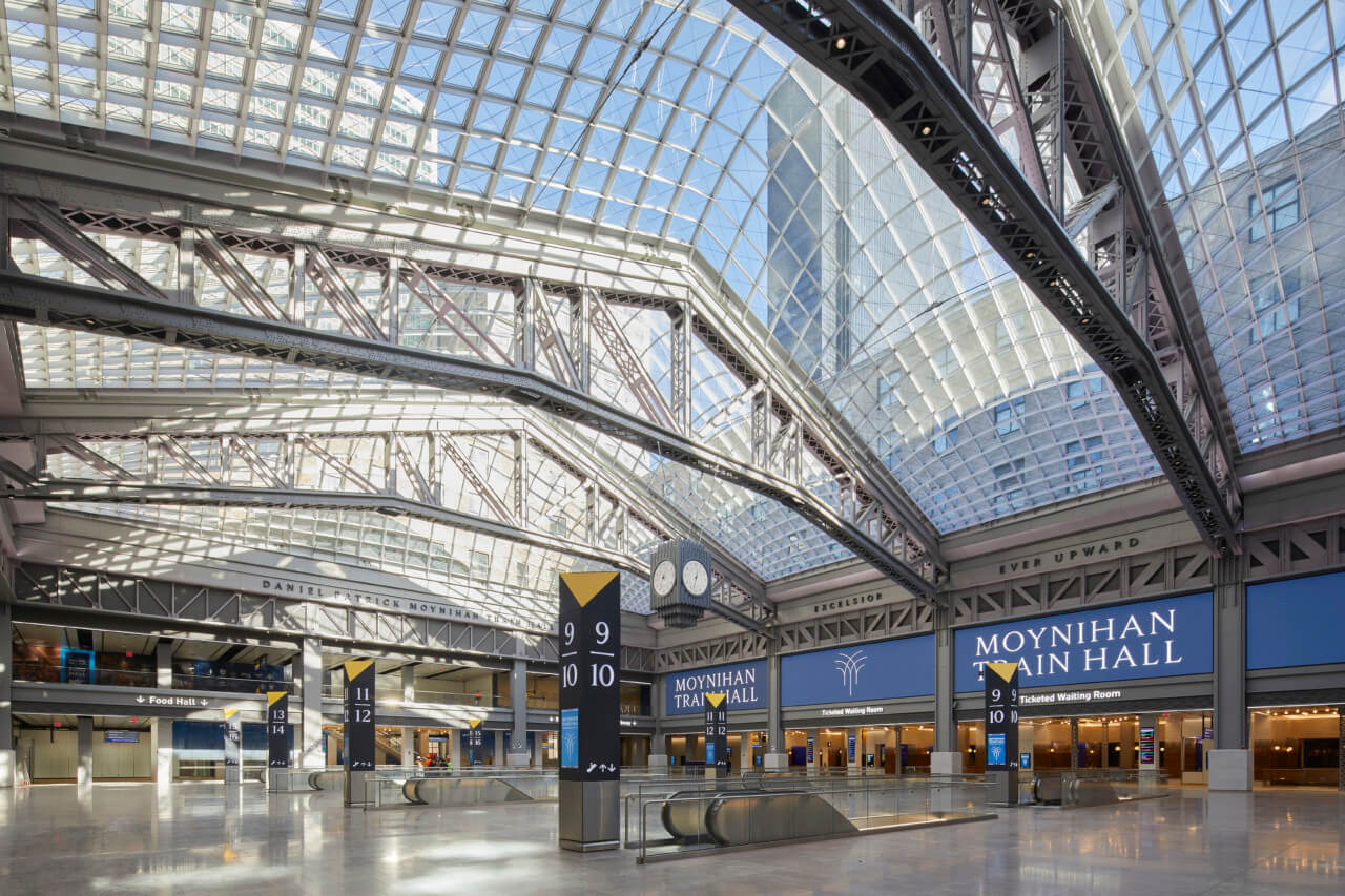inside a glass ceiling at the new penn station platform