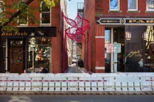 the somepeople designed pink wavy installation in an alley