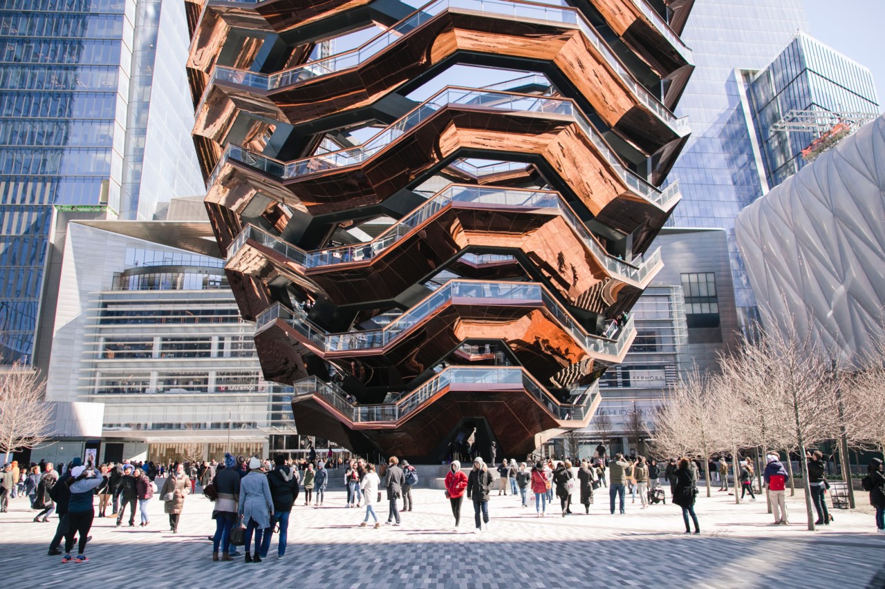 the spiralling copper-clad vessel sculpture with people at the base