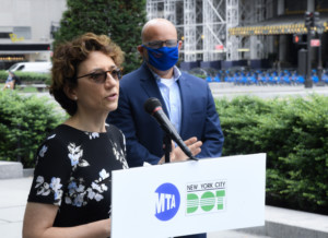 polly trottenberg at a podium with MTA and DOT insignia