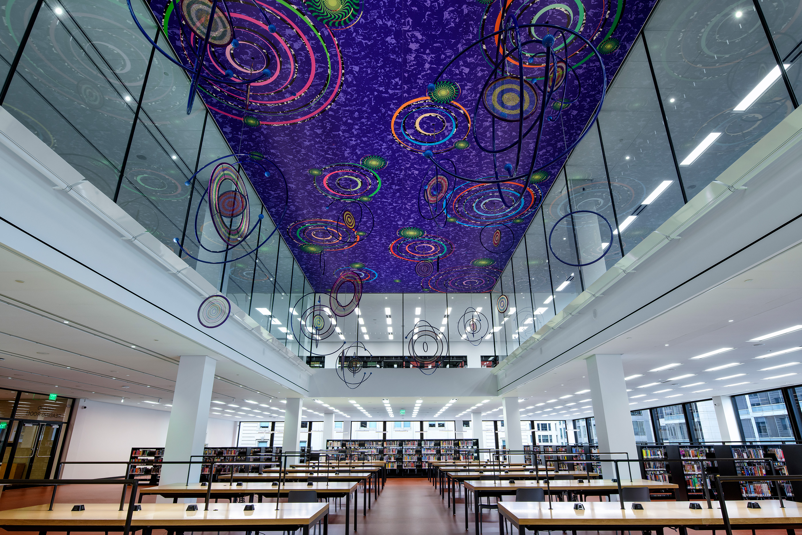 A gallery with purple ceiling and dangling lights
