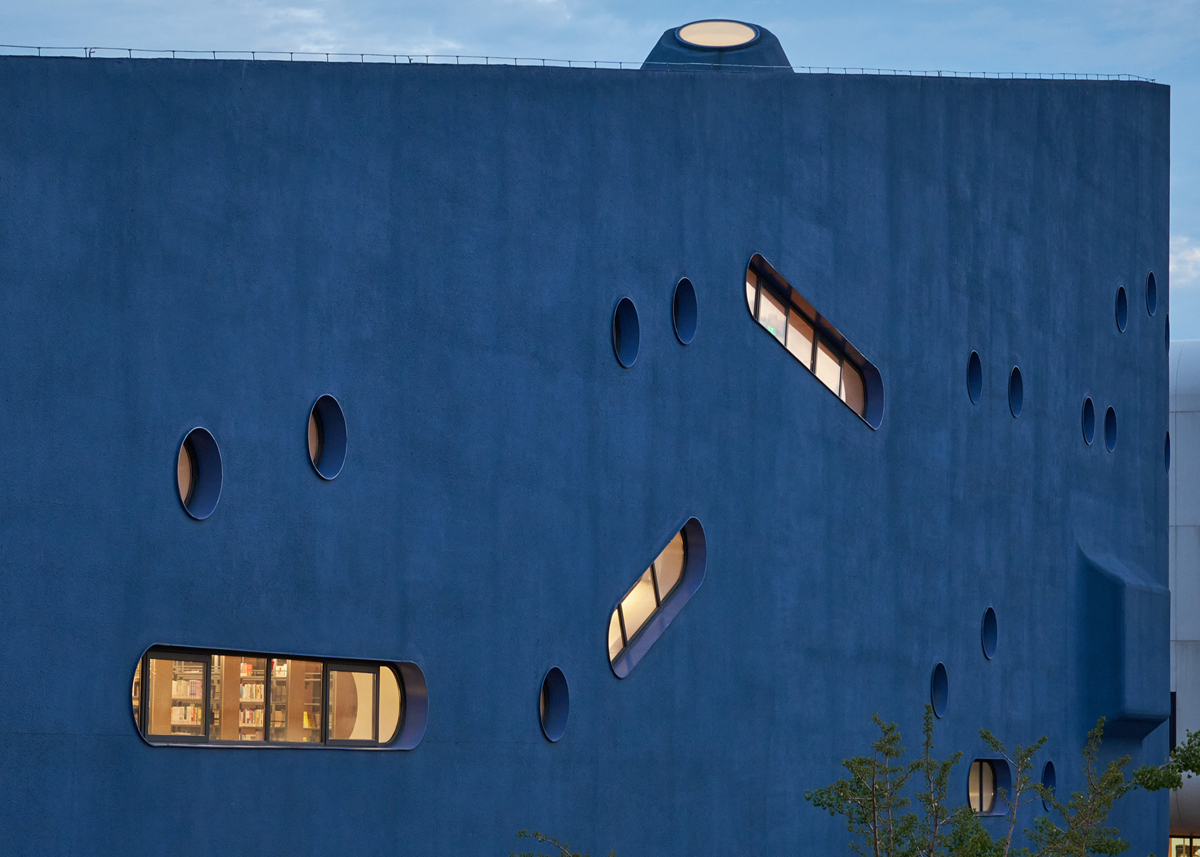 a blue building with irregularly shaped windows
