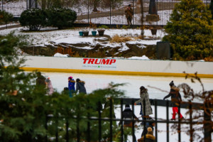 an ice skating rink with a trump sign