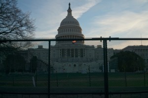 the u.s. capitol building behind fencing
