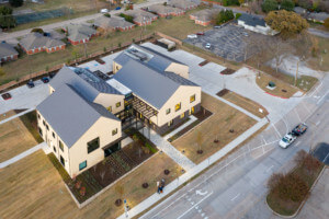 Aerial photo of a health complex shaped like gabled houses designed by Mass