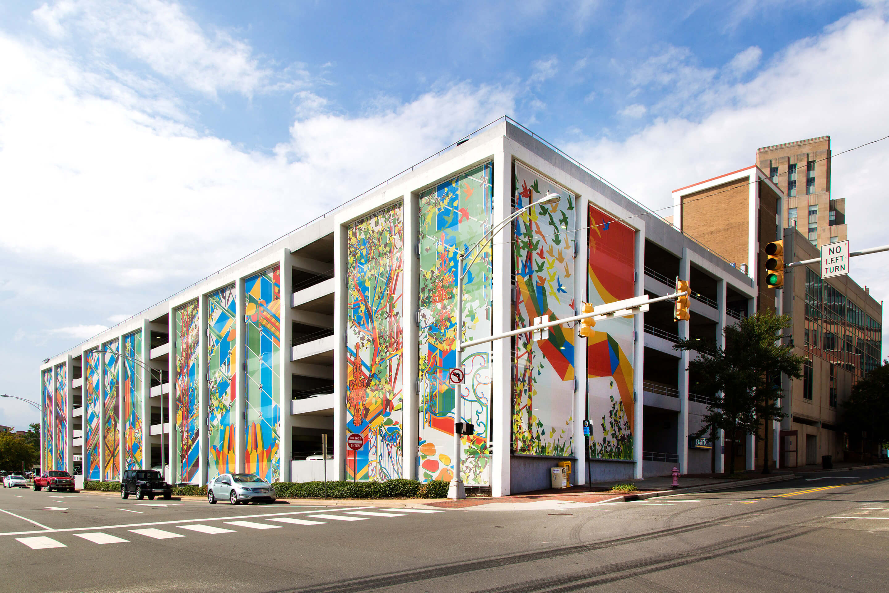 a parking garage enmeshed in colorful fabric by a 2021 USA Fellows