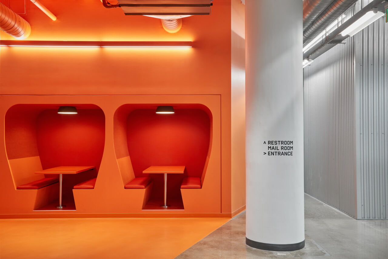orange seating booths carved into a keyhole shape