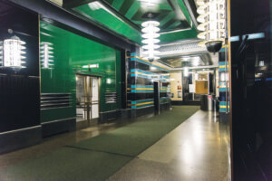 The art moderne lobby of the former McGraw Hill building with green walls and ceiling and spiraling art deco lights