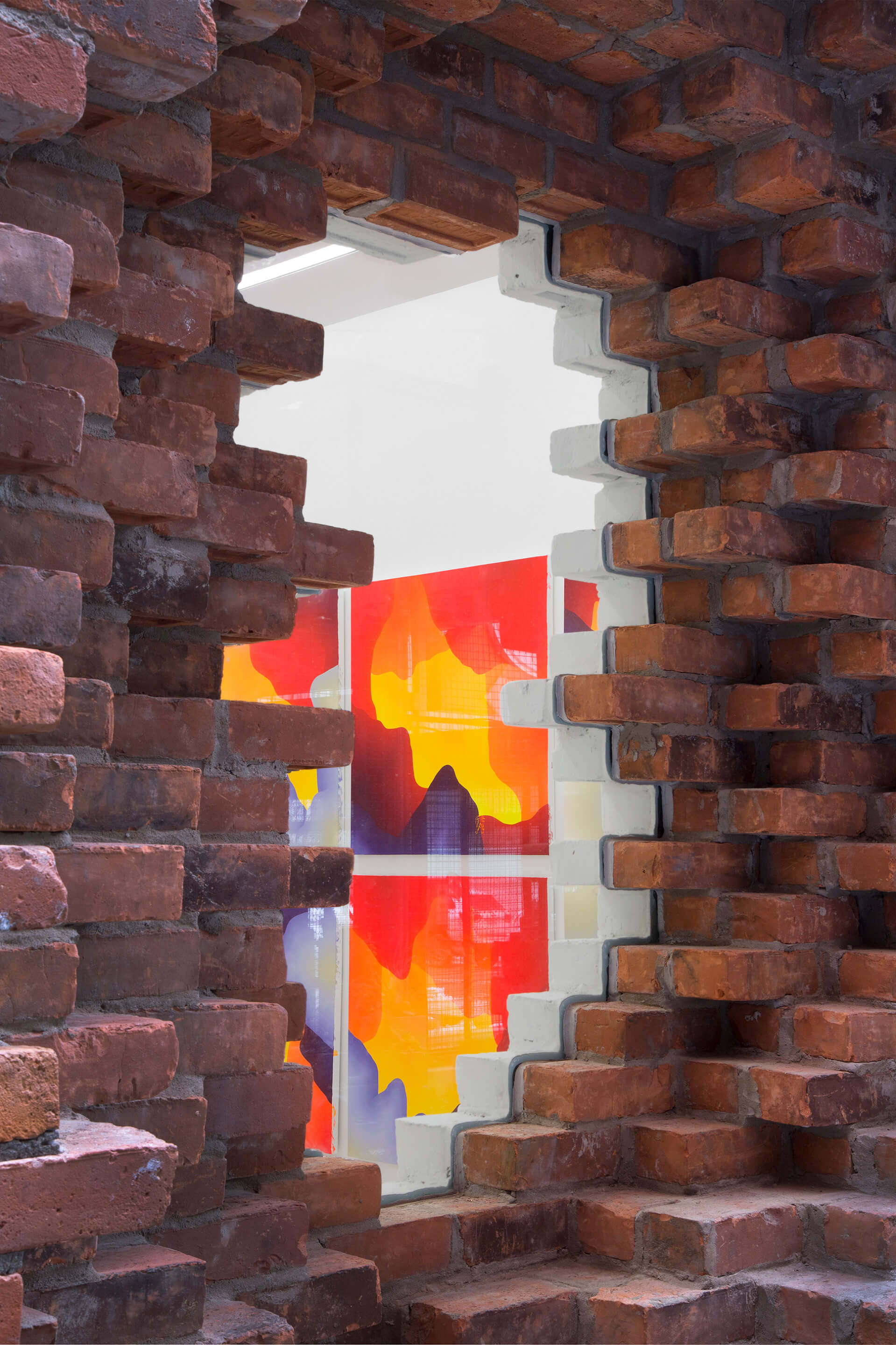view inside of a gallery from a brick opening