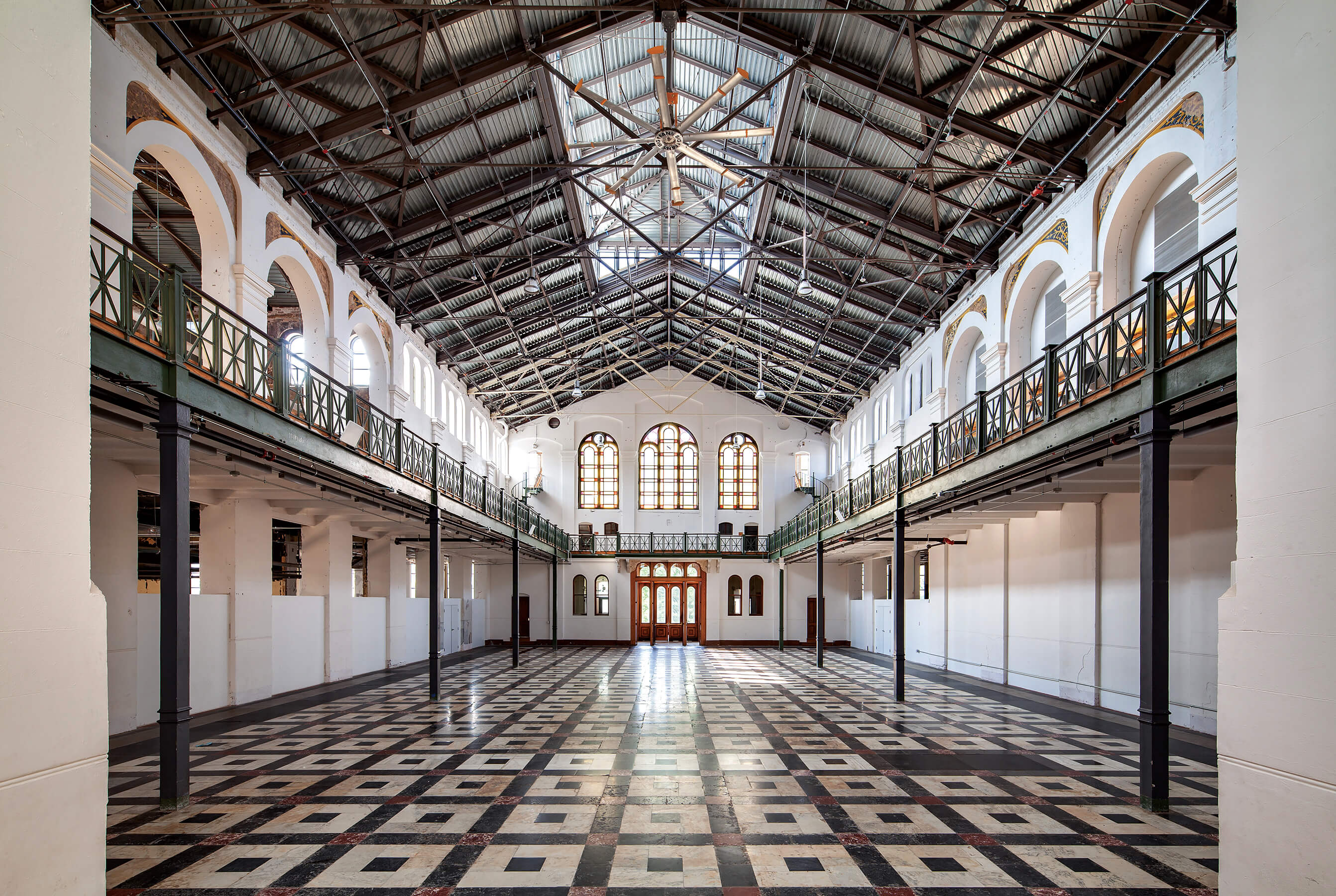 interior of a long restored museum hall with marble floors