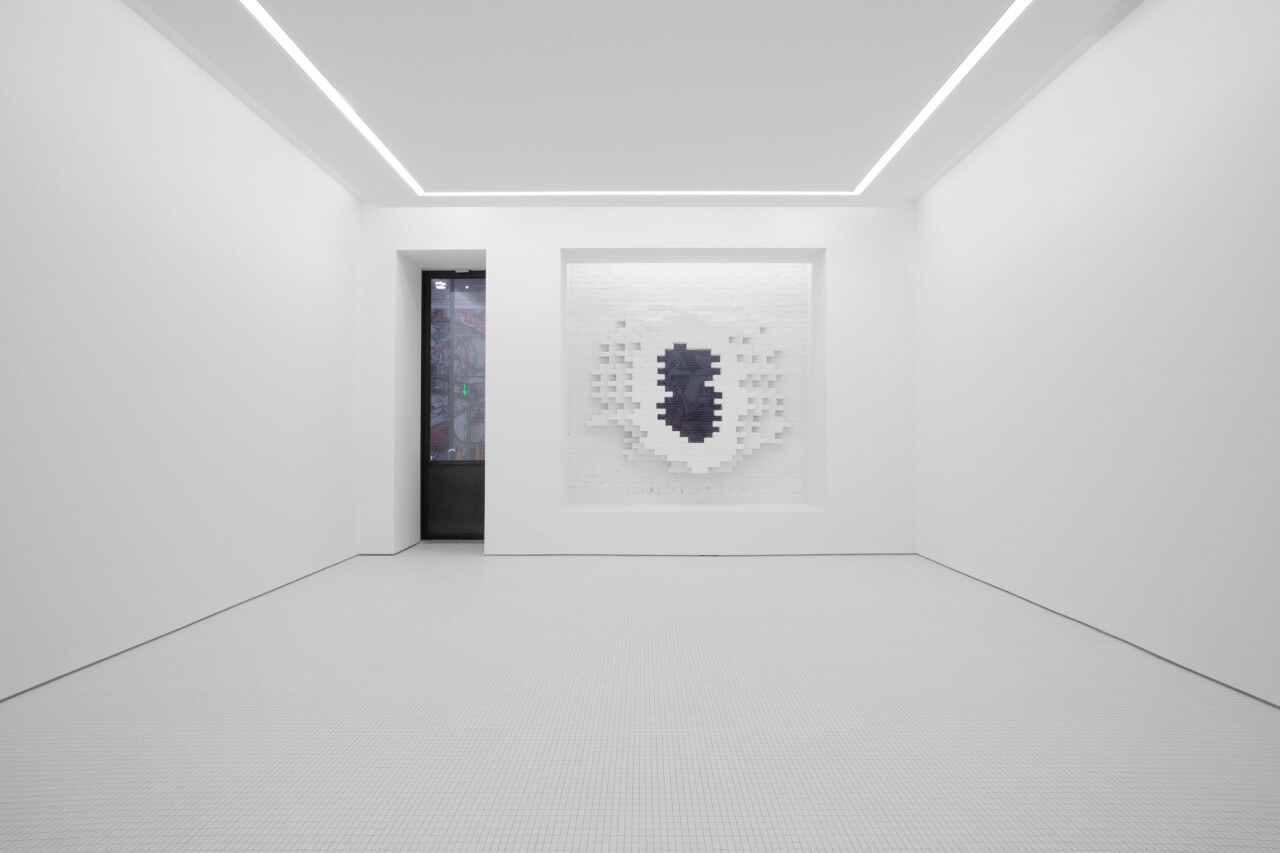 stark white gallery space with a portal opening