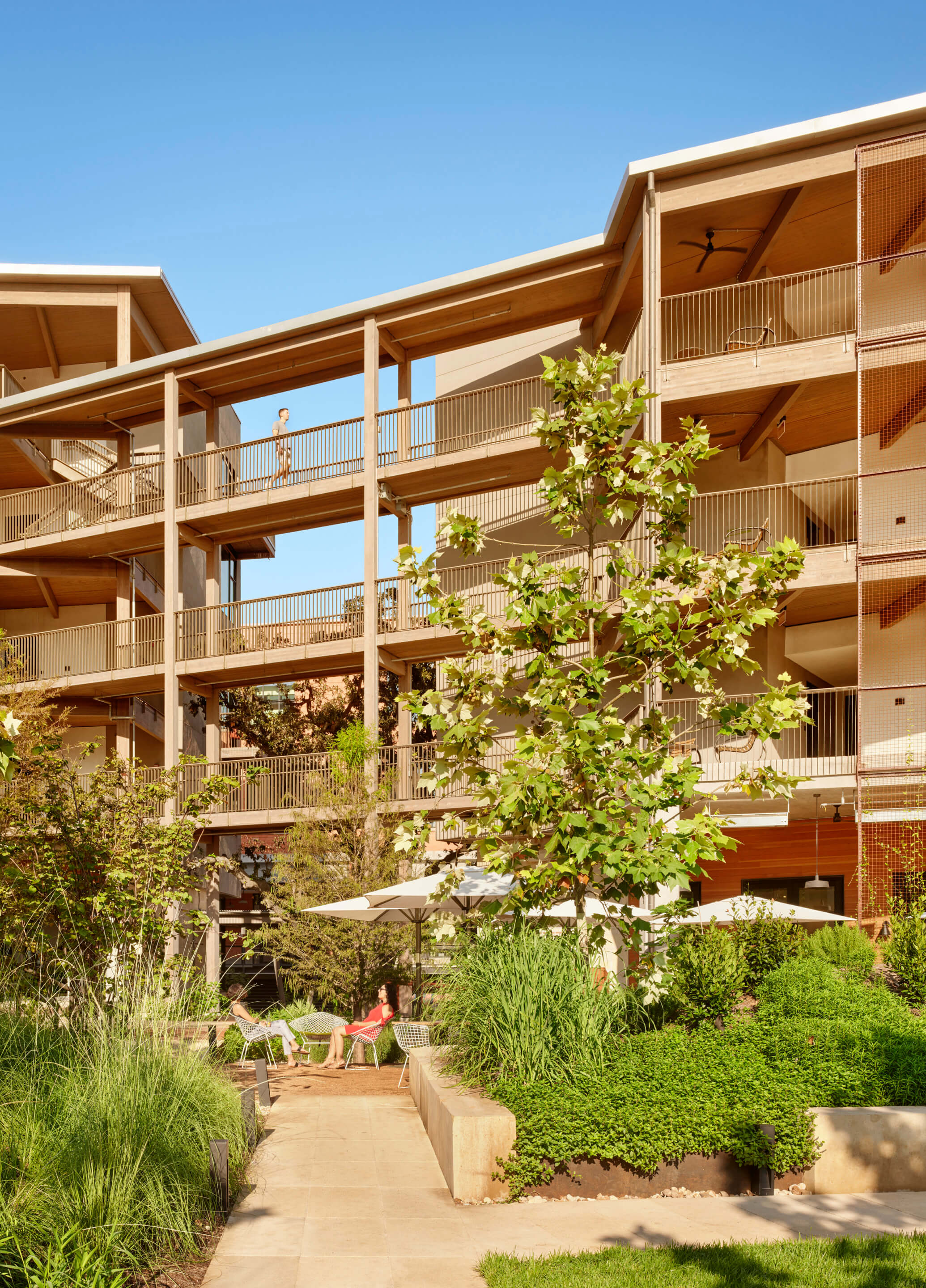 Vertical photo of a hotel with timber flooring and walkways