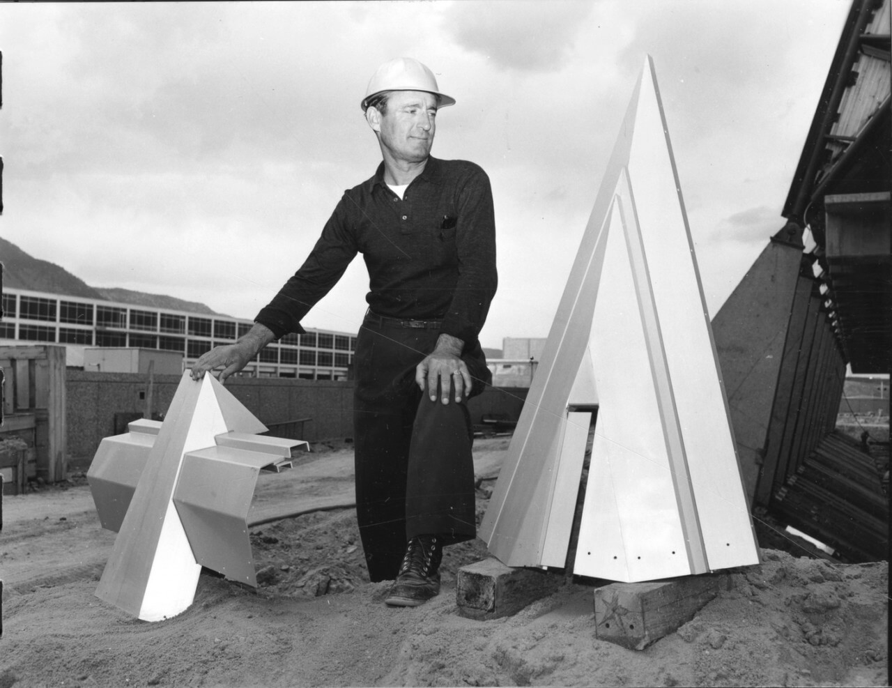 a man posed among peaks of a spire pre installation