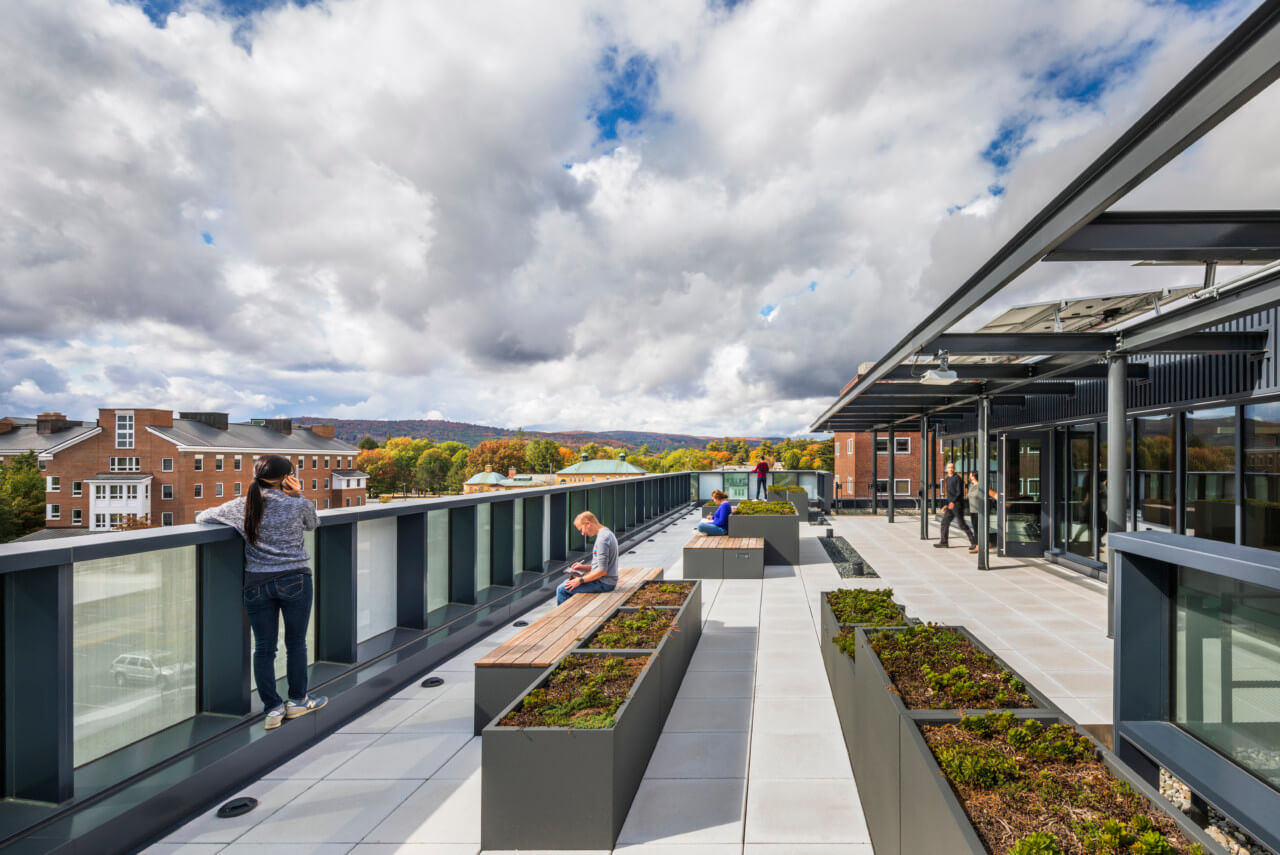 A green roof with people and cantilevering sol.ar panels