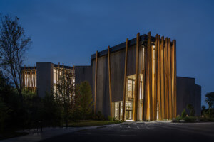 a museum building with timber planks at its entrance pictured at night at the art preserve
