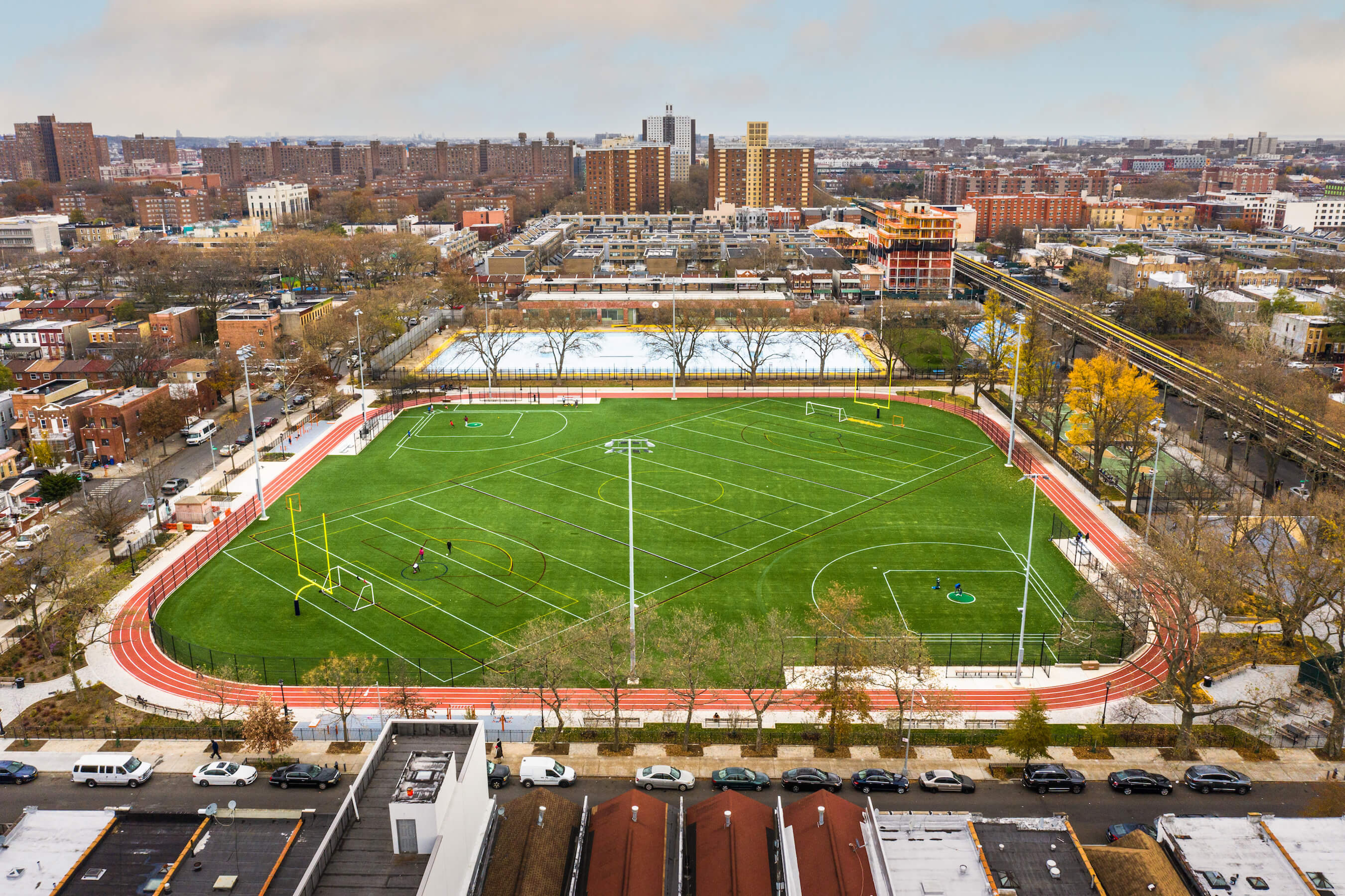 aerial view of a large turf playing field in a city, betsy head park