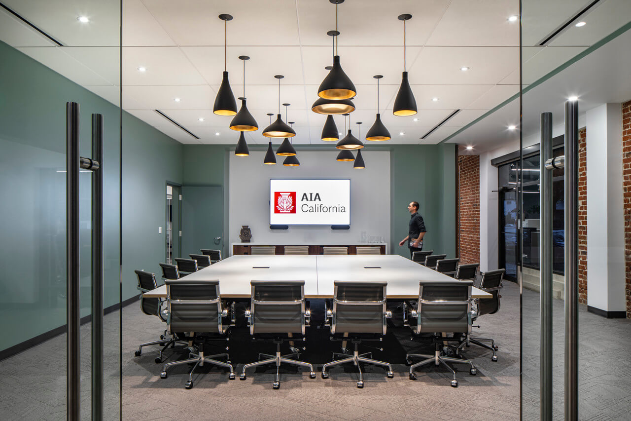 a large conference room with pendant lighting