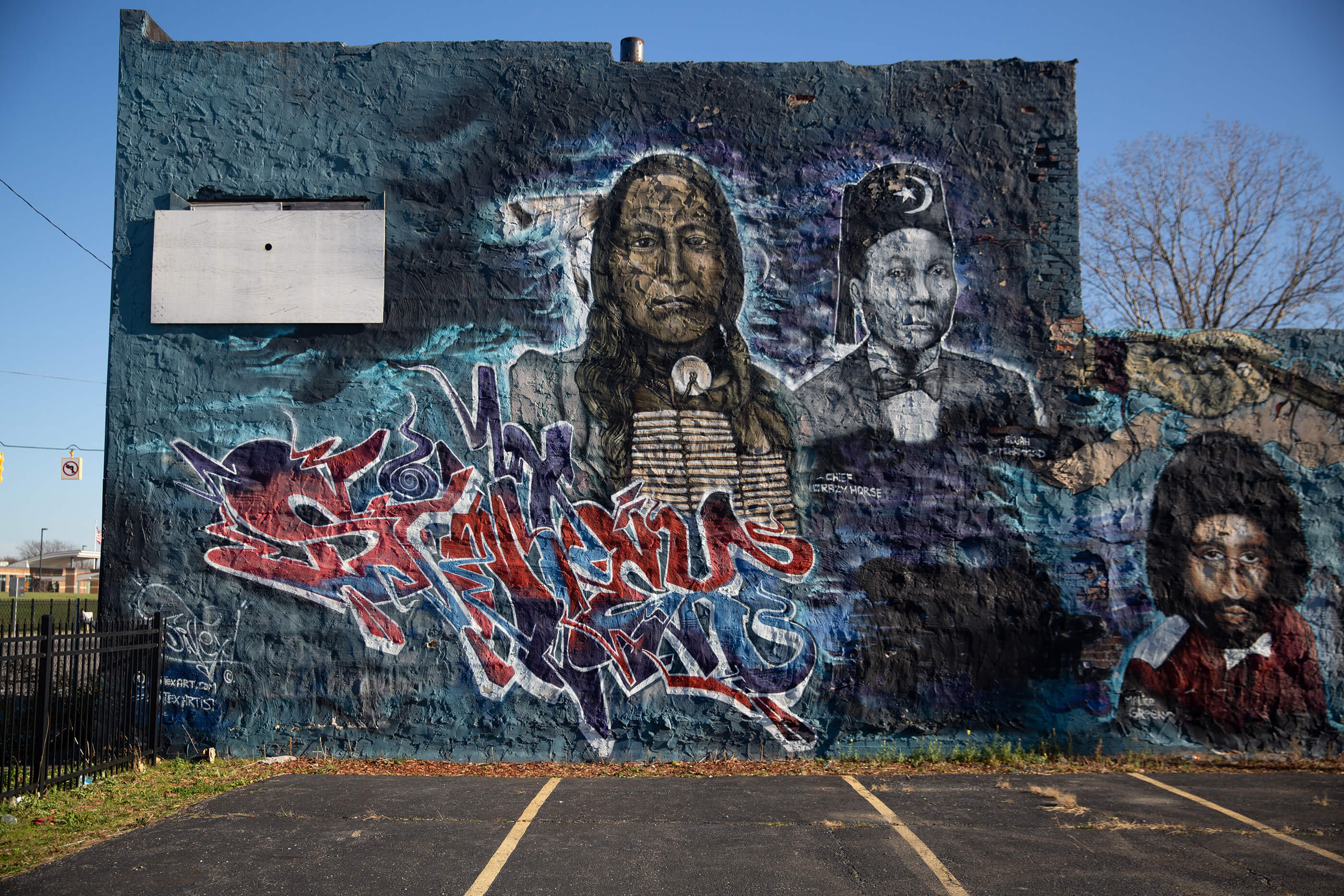 A mural of native americans on the side of a building