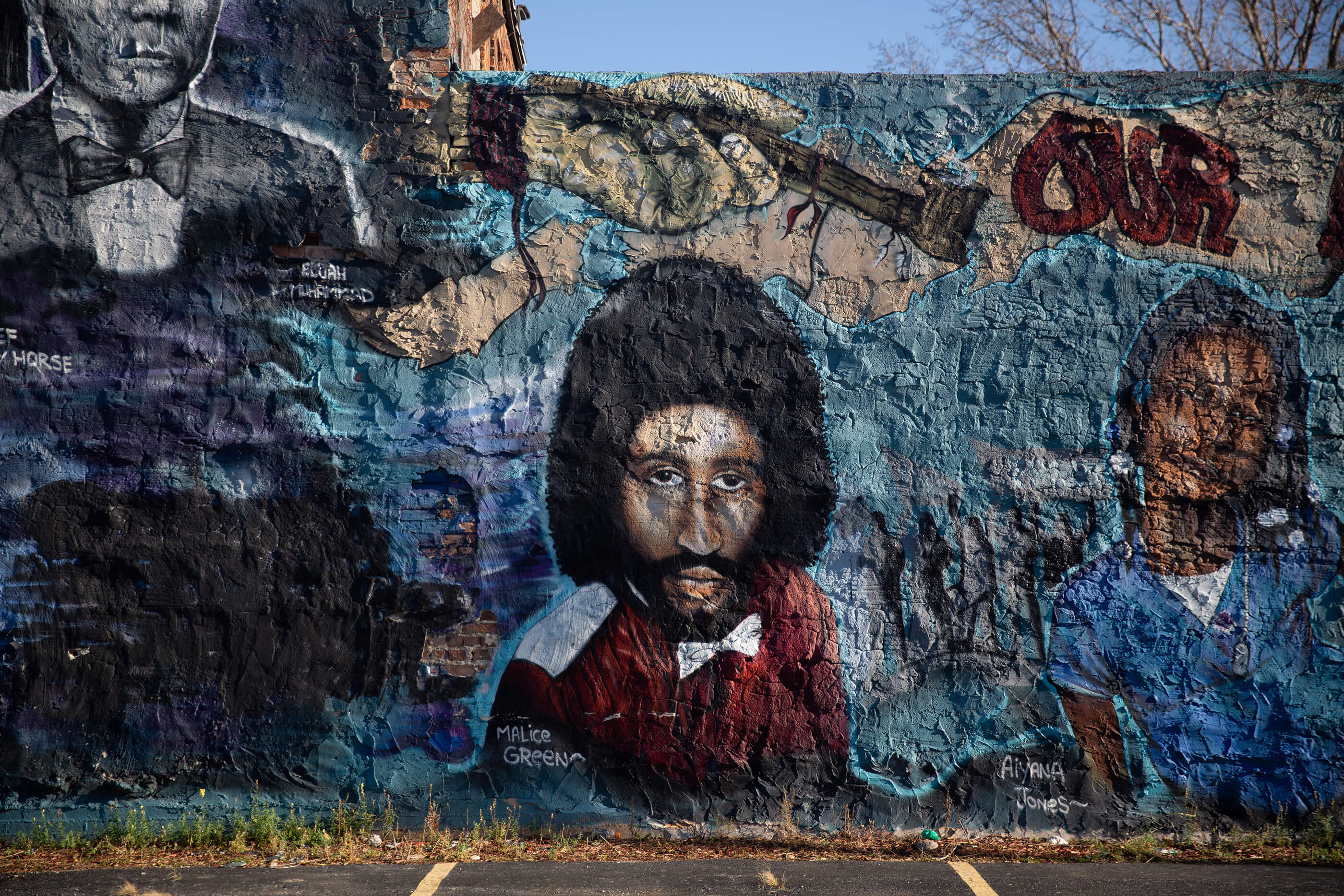a detail shot of a mural with a man with an afro at the love building