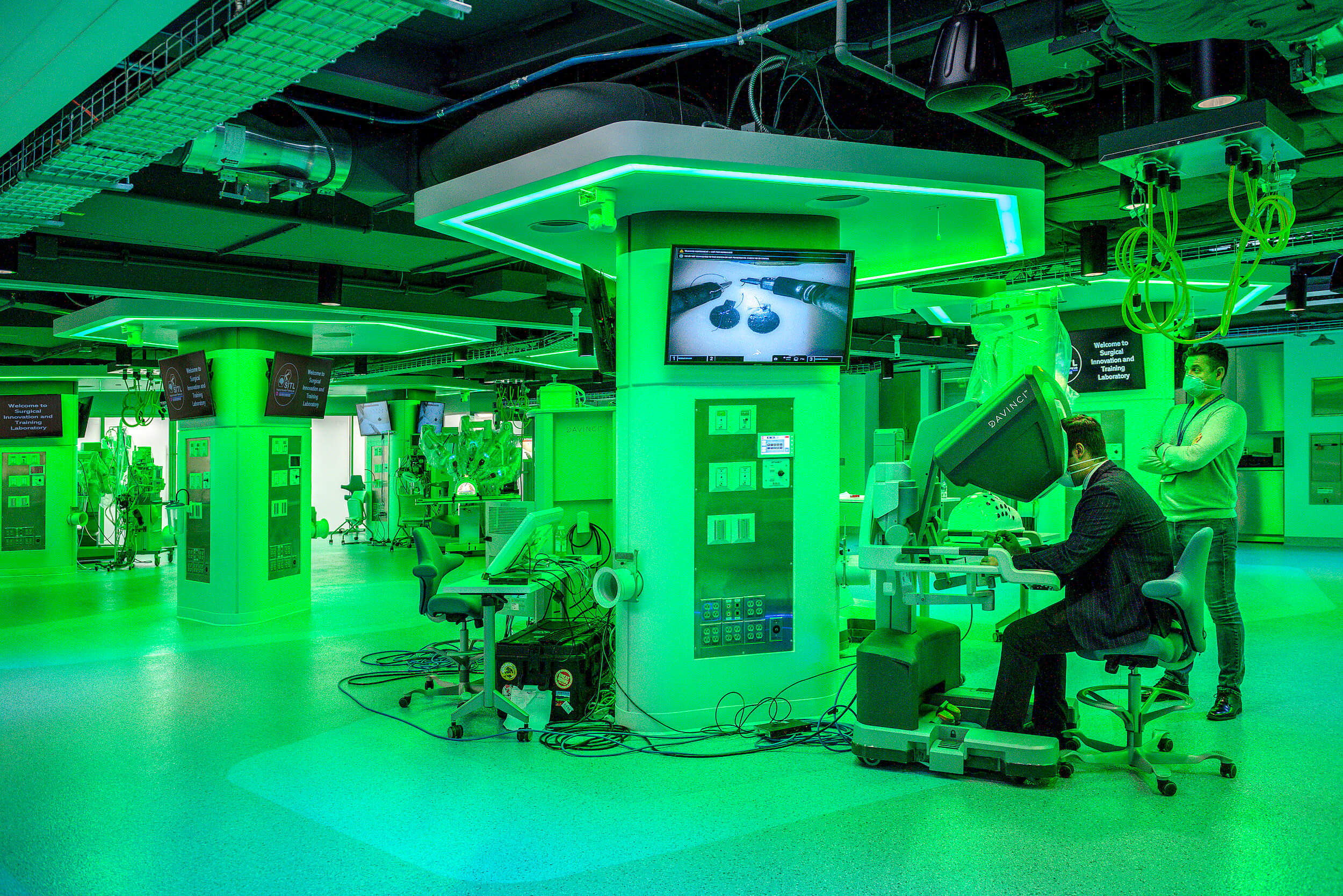 a green-hued medical laboratory with machines