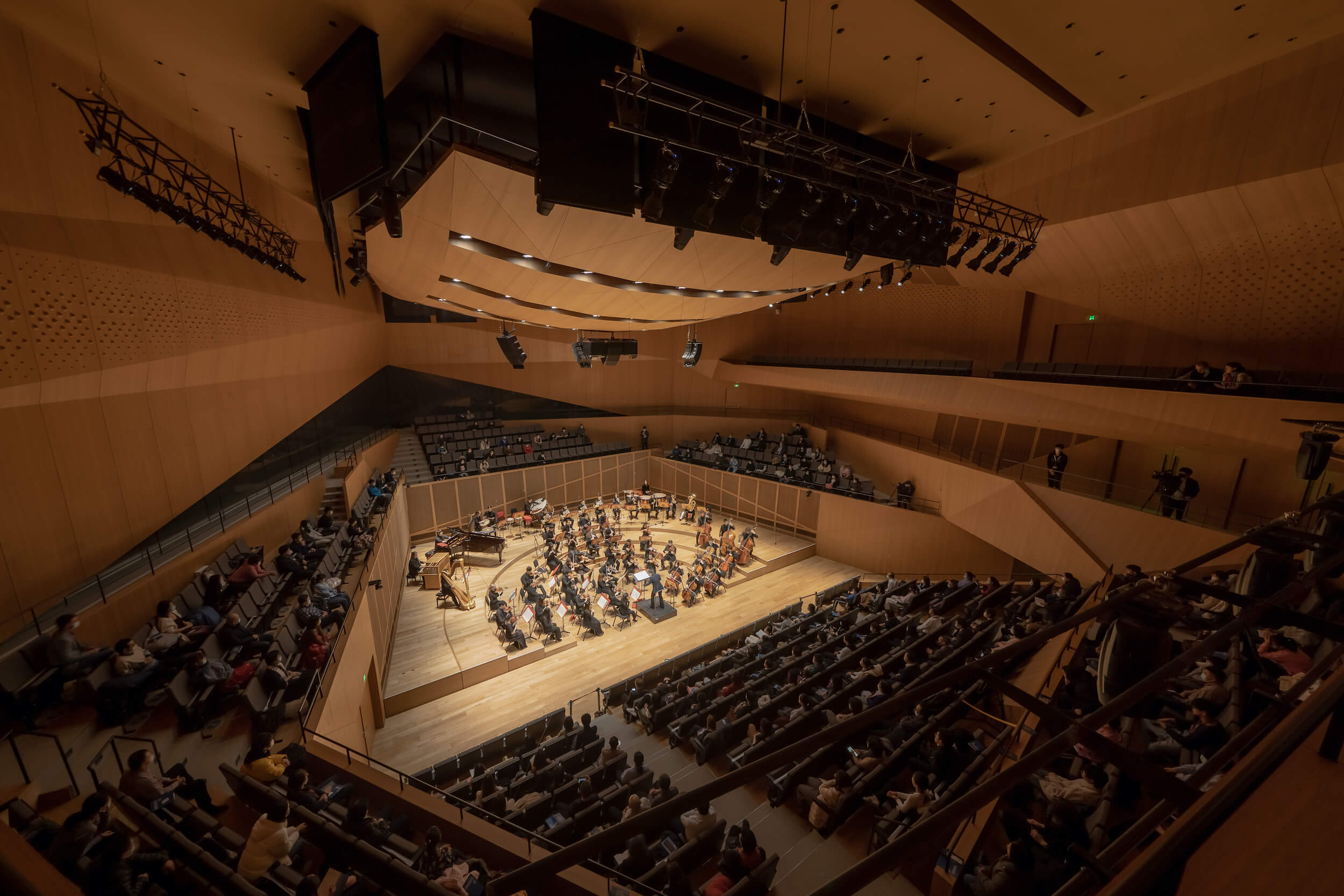 Inside a concert hall decked out in timber panels
