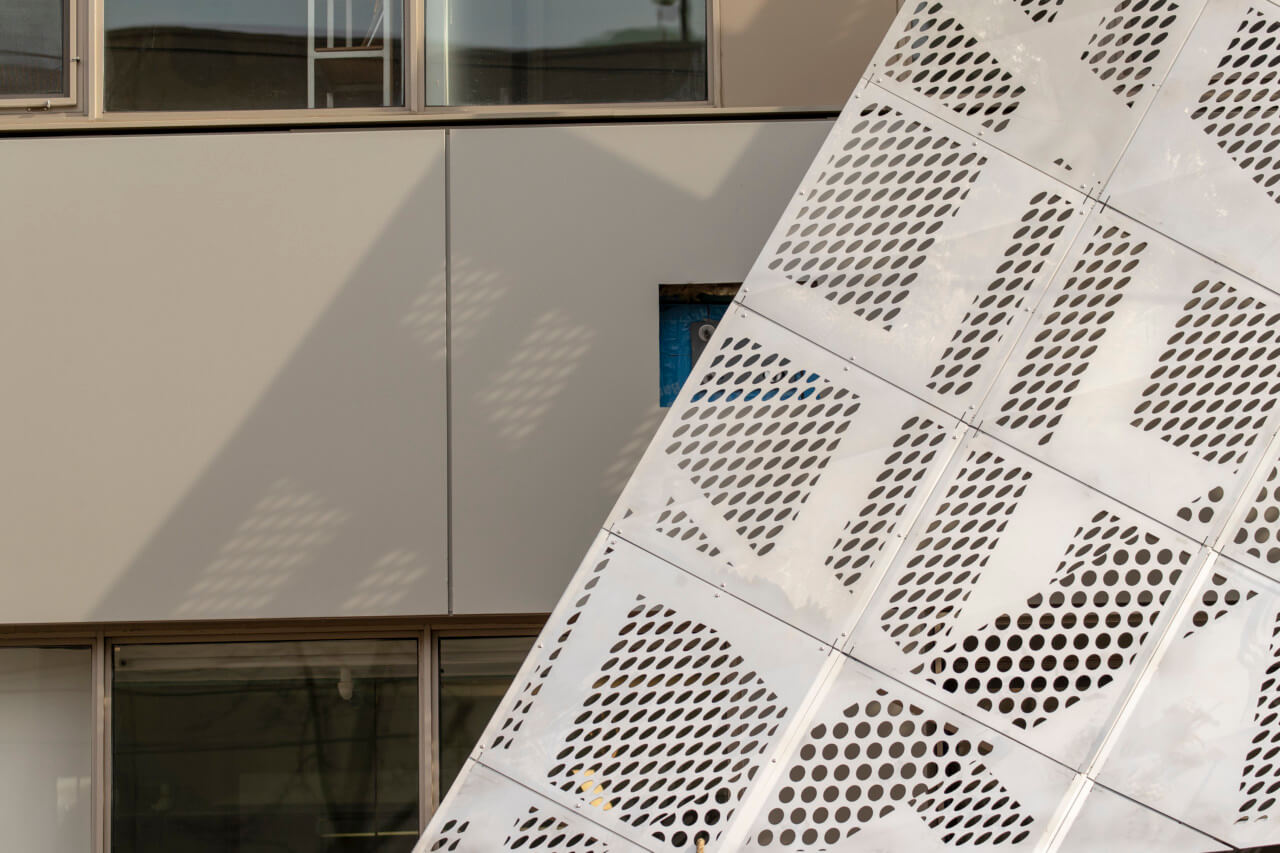stainless steel perforation on the wing of the facade