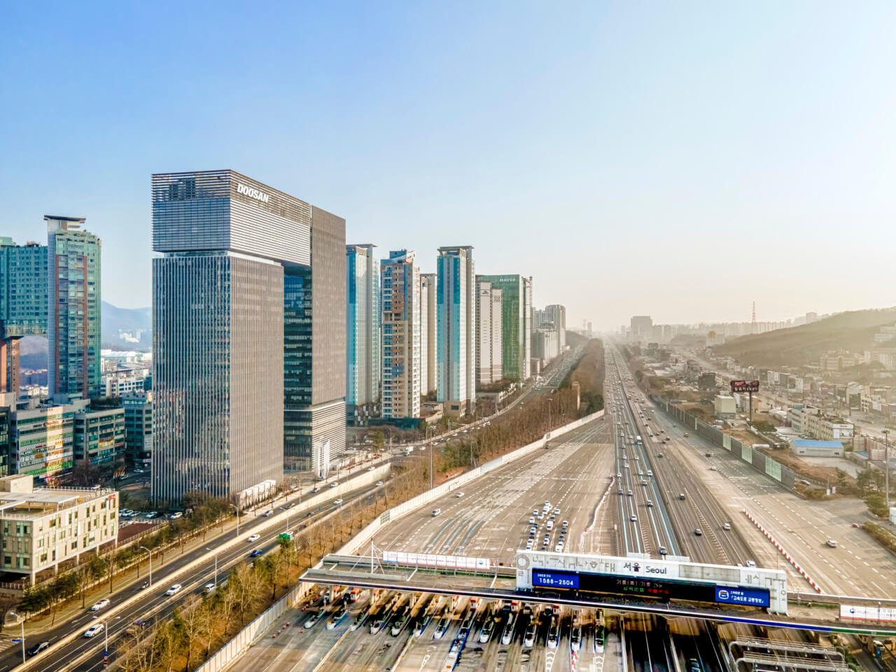 modern high-rises line a freeway in korea