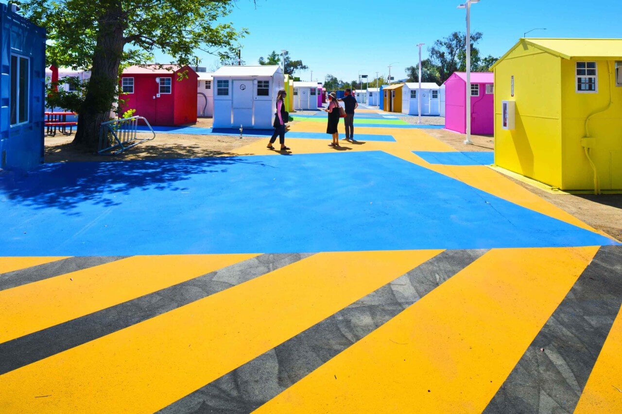blue and yellow-striped pavement with bold colored tiny houses