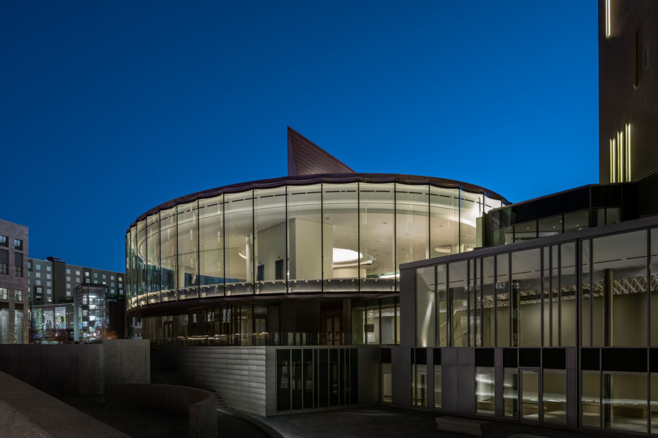 an elliptical museum building pictured at night