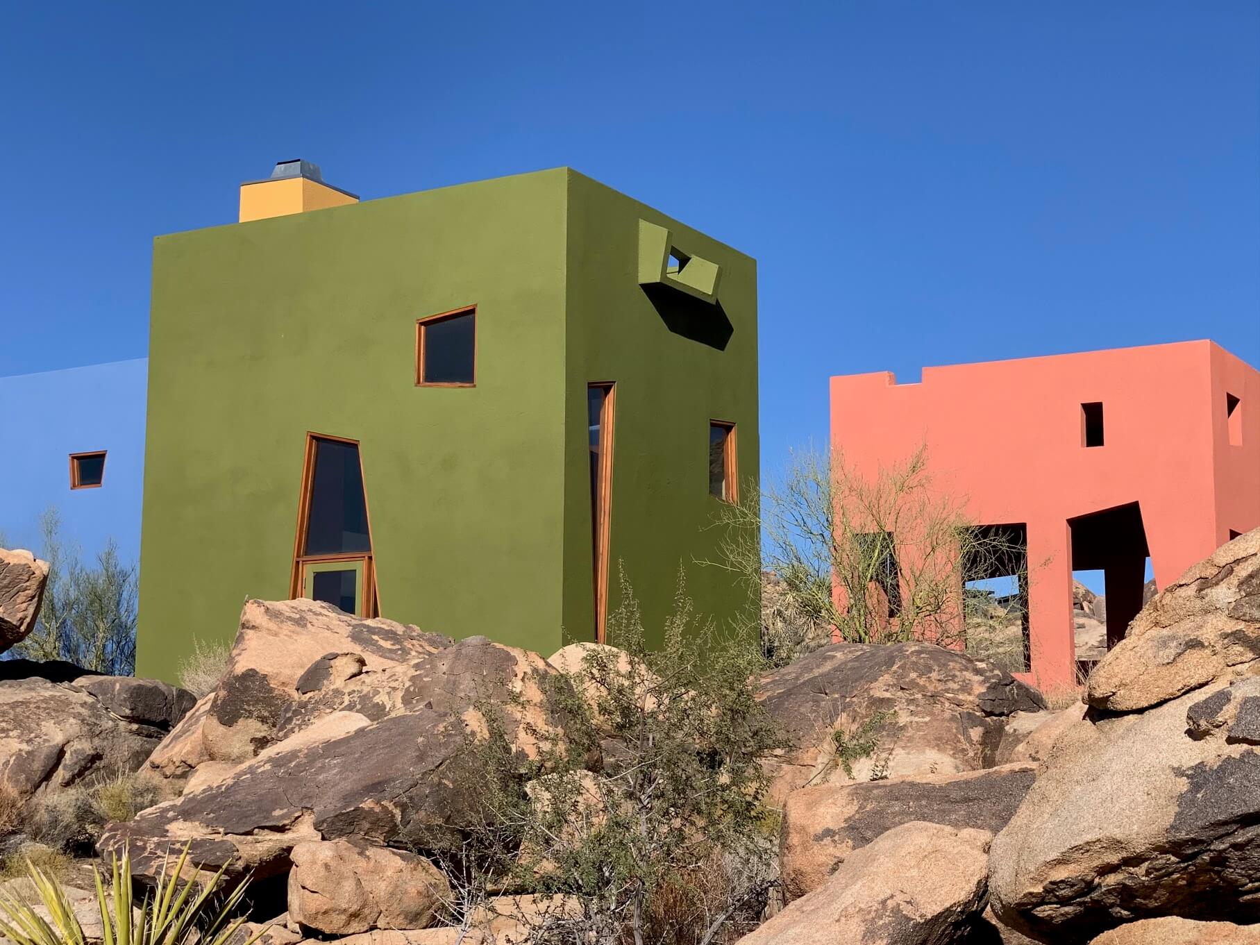 Exterior of blocky colorful homes amid mountains