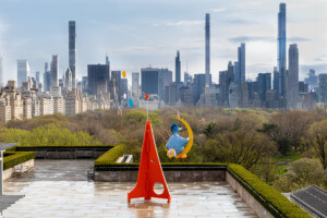 Installation view of as long as the sun lasts showing a big bird sculpture against manhattan's skyline