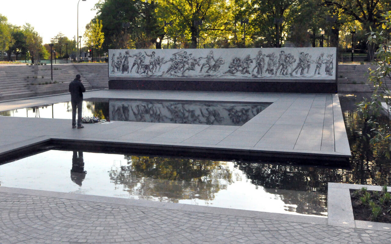 A person on a water feature at the World war 1 memorial