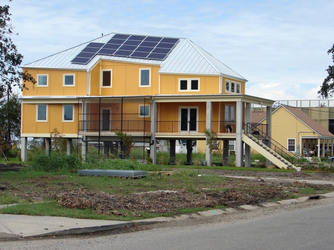 an elevated home with askew solar panels