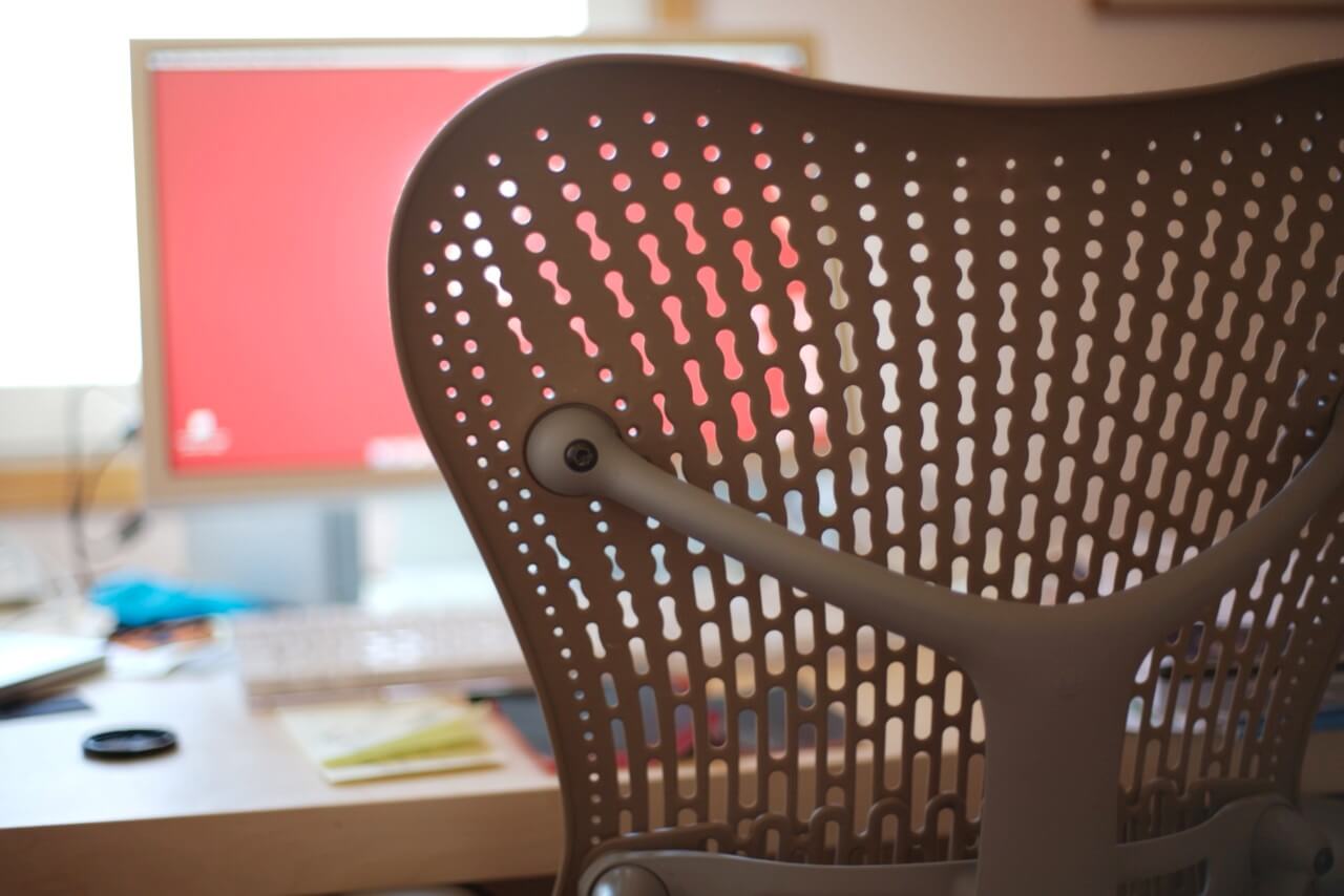 the webbed back of a modern office chair