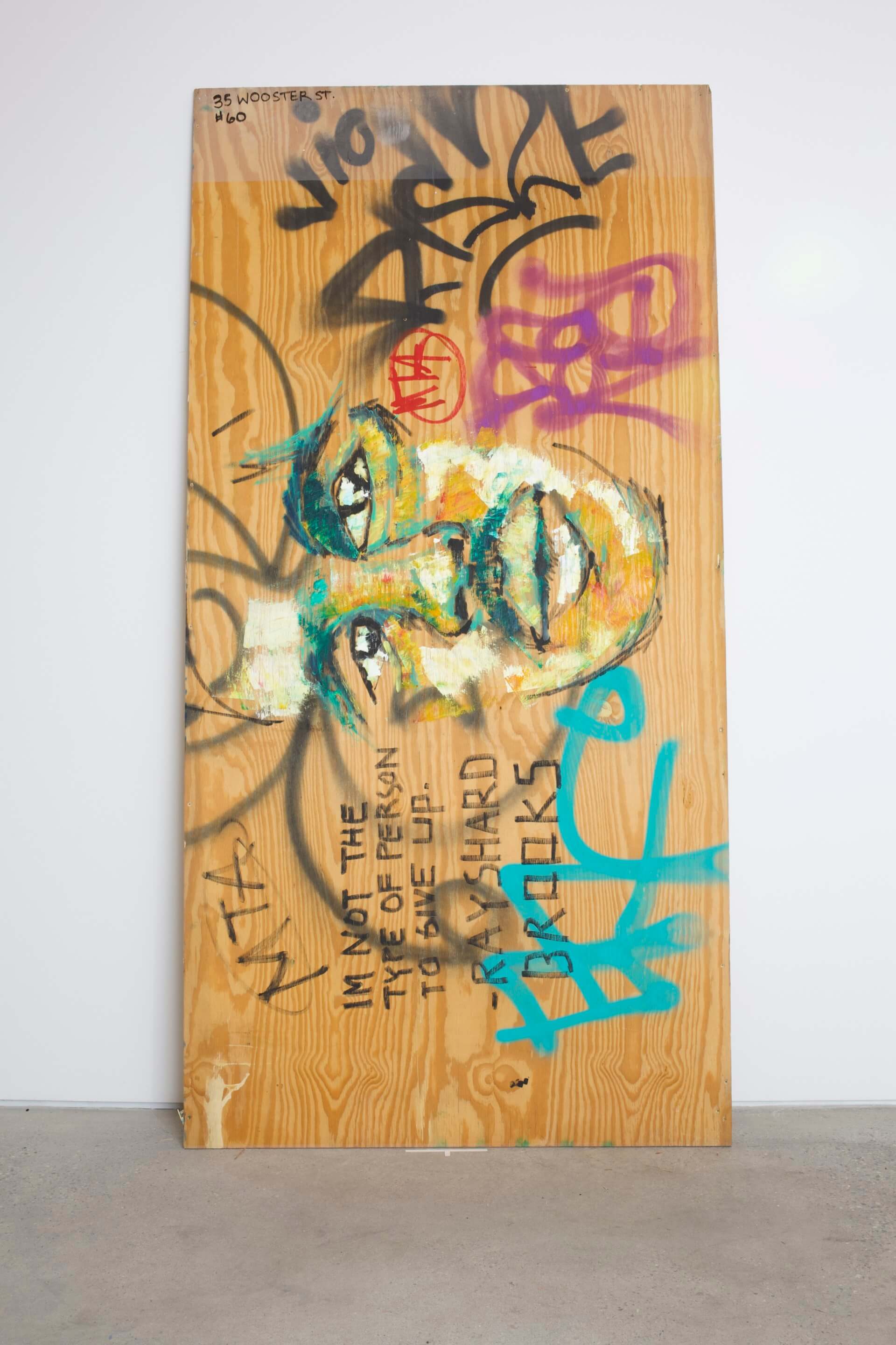 a graffiti-covered plywood board